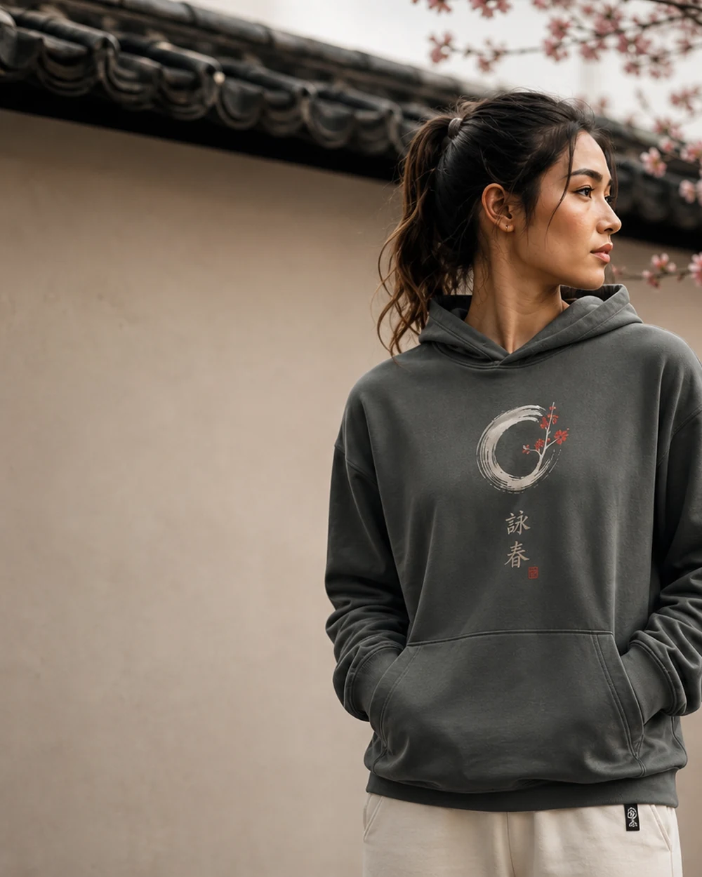 Signature Hoodie — model wearing sage-charcoal hoodie in lifestyle shoot